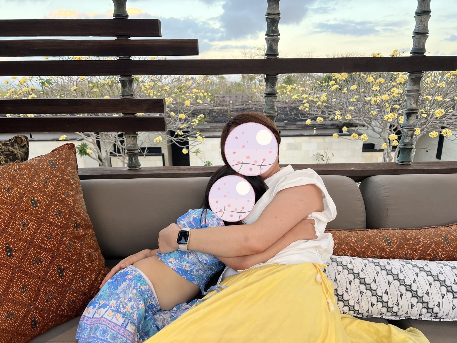 Mother and child embracing on the terrace at dusk 
