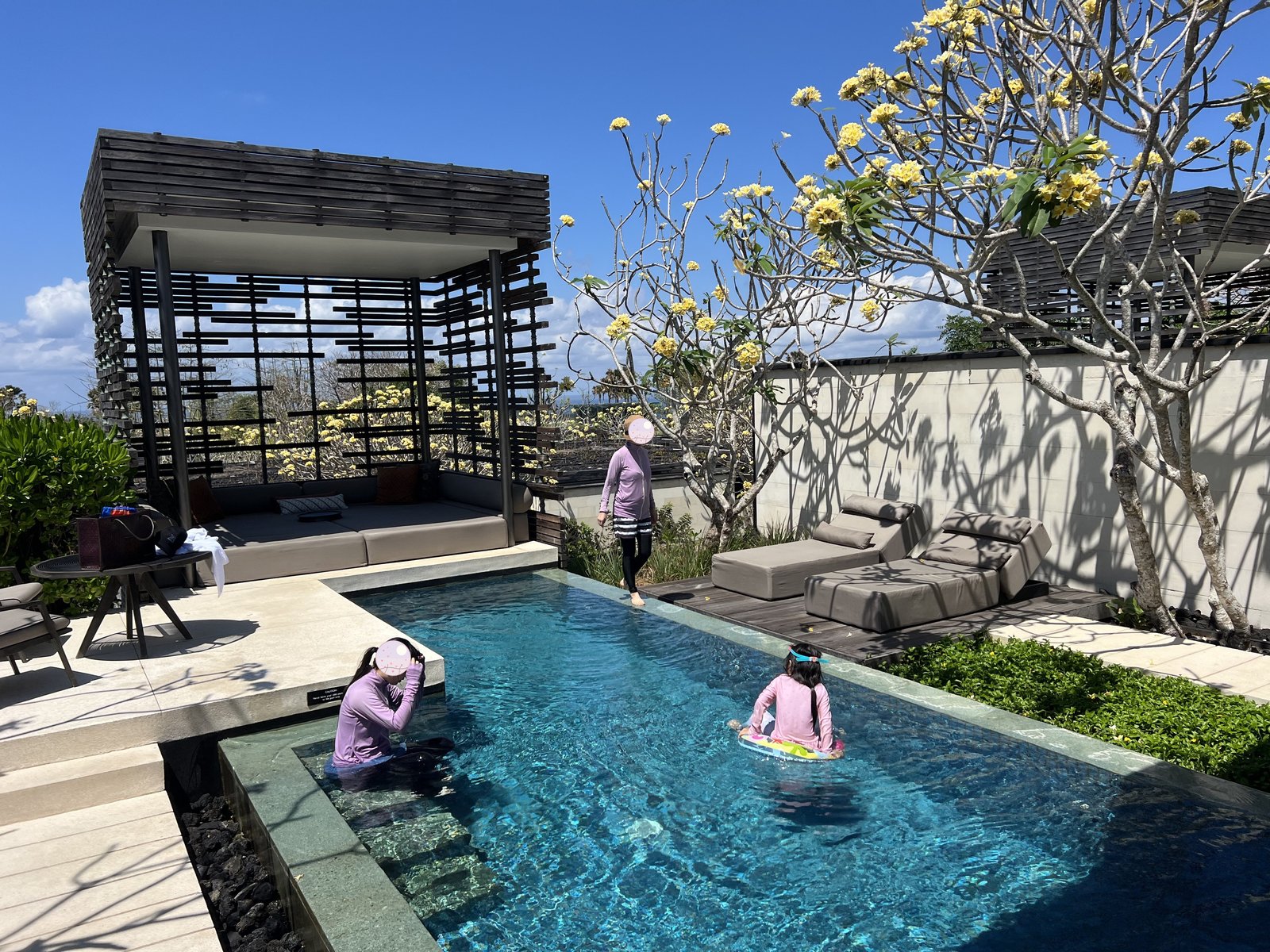 Our child swimming in the private villa pool (with a flamingo float)