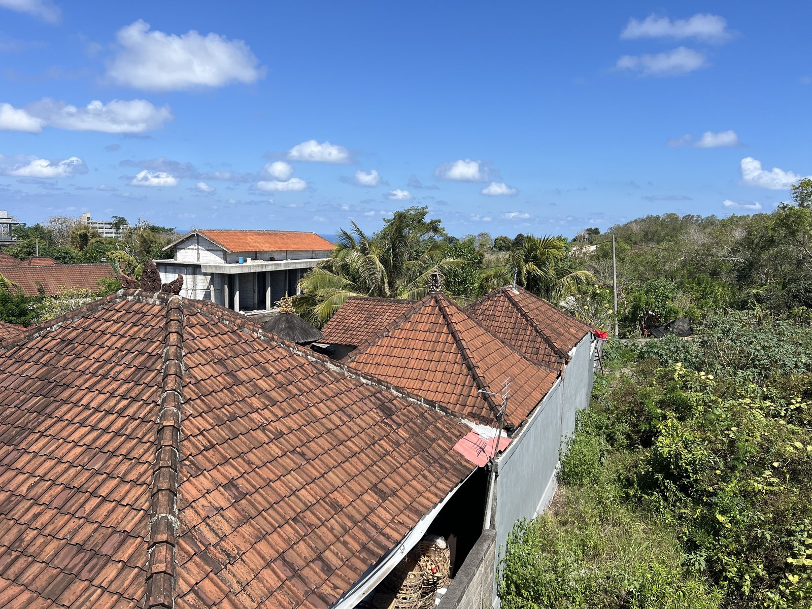 Blue sky beyond the red-tiled roofs