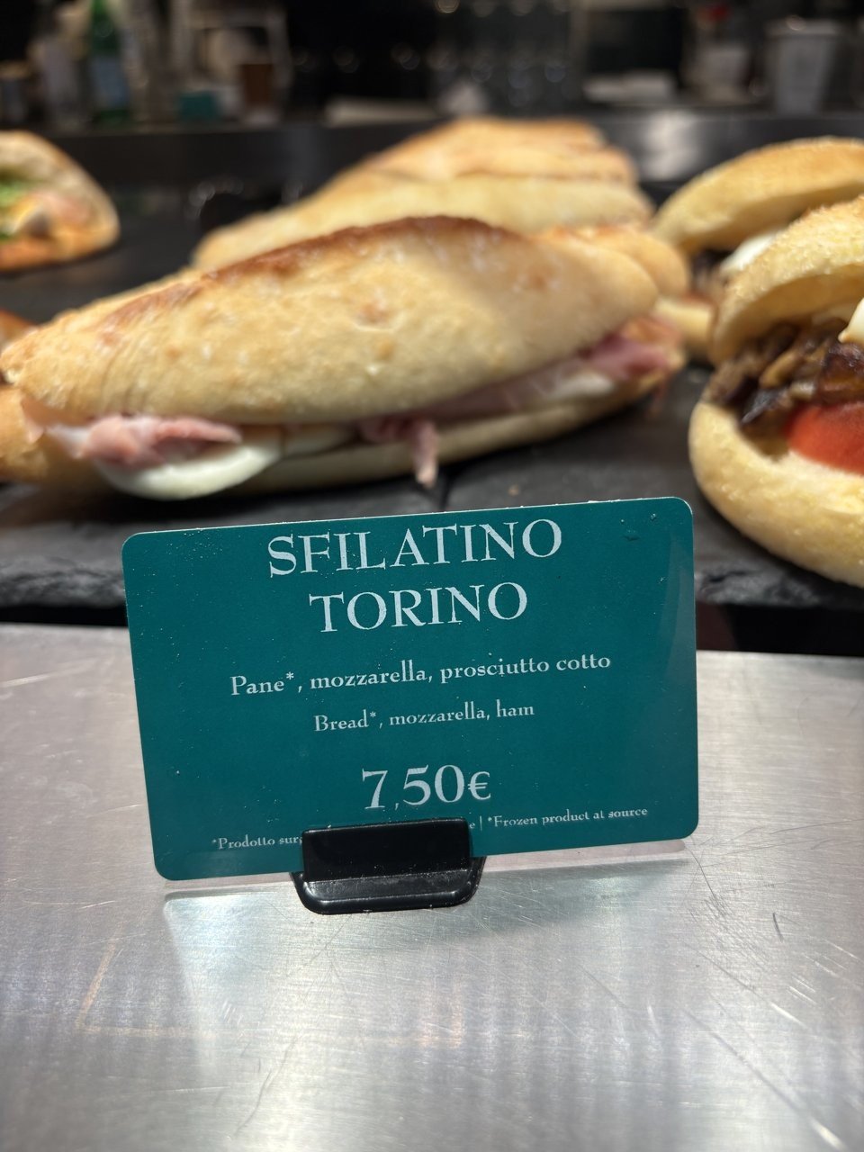 A panino (sandwich) from a station or street stand, price clearly shown