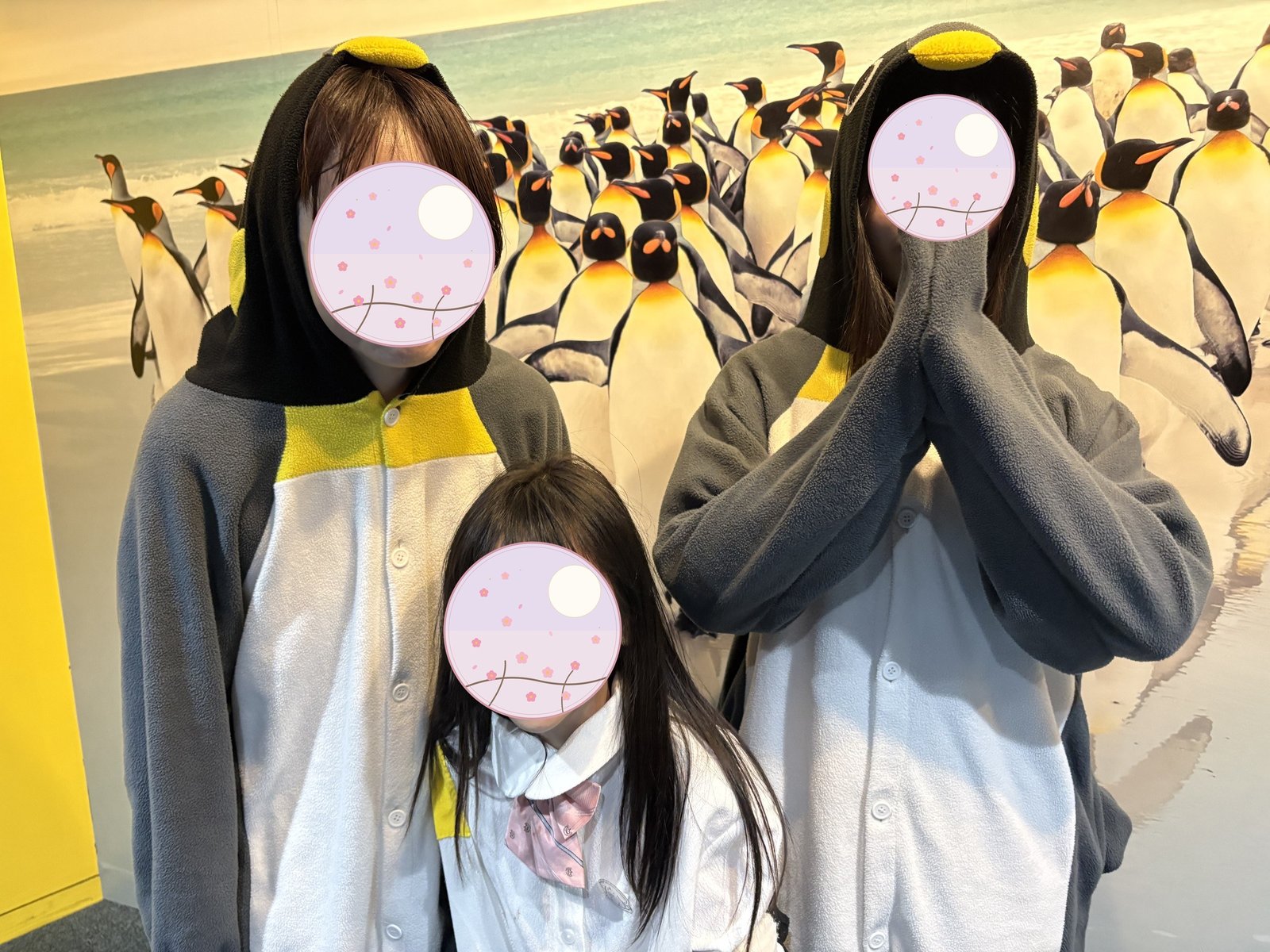 Posing in penguin costumes for a photo 